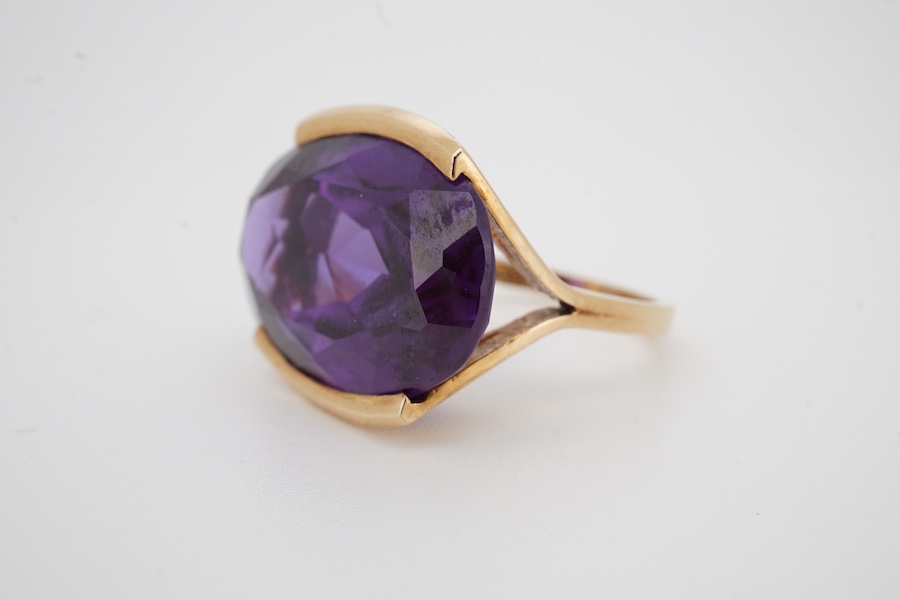 An 18k and single stone oval cut synthetic colour change corundum set dress ring, size P, gross weight 10.6 grams. Condition - good